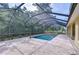 Beautiful screened-in pool with stone pavers and ample space for relaxation at 3323 Anna George Dr, Valrico, FL 33596