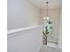 Well-lit staircase with carpet and wrought iron banister and backyard view at 3323 Anna George Dr, Valrico, FL 33596
