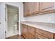 Convenient wet bar with custom cabinets, countertops and opens to tiled bathroom at 3323 Anna George Dr, Valrico, FL 33596