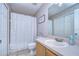 Functional bathroom featuring a vanity with sink, toilet, and shower with curtain, offering essential amenities at 3456 Castle Stone Ct, Valrico, FL 33594