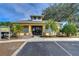 Community clubhouse entrance, featuring gated access, palm trees, and a welcoming facade at 3456 Castle Stone Ct, Valrico, FL 33594