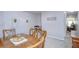 Bright dining area features carpeted floors, a wooden table with chairs, and modern wall decor at 3456 Castle Stone Ct, Valrico, FL 33594