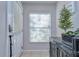 Bright foyer features tiled flooring, a window with blinds, and a stylish accent table at 3456 Castle Stone Ct, Valrico, FL 33594