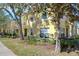 Charming townhome showing lush greenery, mature trees, and a manicured lawn enhance curb appeal at 3456 Castle Stone Ct, Valrico, FL 33594
