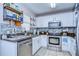Updated kitchen features granite countertops, stainless steel appliances, tile backsplash, and white cabinets at 3456 Castle Stone Ct, Valrico, FL 33594
