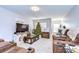 Cozy living room features plush recliners, a festive Christmas tree, and bright natural light at 3456 Castle Stone Ct, Valrico, FL 33594