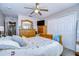 This spacious main bedroom features a ceiling fan, a closet, and ample space for dressers at 3456 Castle Stone Ct, Valrico, FL 33594