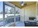 Cozy screened patio with ceiling fan and outdoor seating, overlooking the backyard at 3456 Castle Stone Ct, Valrico, FL 33594