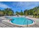 Community swimming pool with deck chairs surrounded by trees, ideal for summer relaxation and enjoyment at 3456 Castle Stone Ct, Valrico, FL 33594