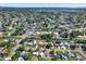 Expansive aerial view of a neighborhood with mature trees, single-Gathering homes, and clear blue skies at 3501 63Rd N St, St Petersburg, FL 33710