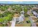 Beautiful aerial view of a home with a long driveway, lush landscaping, and mature trees at 3501 63Rd N St, St Petersburg, FL 33710