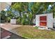 Landscaped backyard features a shed with red door, brick pavers, and privacy fence at 3501 63Rd N St, St Petersburg, FL 33710