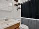 Well-lit bathroom with modern fixtures and striped shower curtain at 3501 63Rd N St, St Petersburg, FL 33710