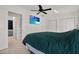 Bright bedroom features a tv and a view to the bathroom at 3501 63Rd N St, St Petersburg, FL 33710