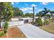 Charming single-story home with a carport, well-maintained lawn, and a white fence offering curb appeal at 3501 63Rd N St, St Petersburg, FL 33710