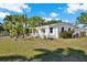 Charming single-story home features well-maintained landscaping, mature trees, and a white facade at 3501 63Rd N St, St Petersburg, FL 33710
