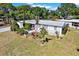 Charming single-story home features well-maintained landscaping, mature trees, and a white facade at 3501 63Rd N St, St Petersburg, FL 33710