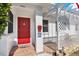 Inviting entryway with a bright red front door, decorative lattice work, and a 'welcome' sign at 3501 63Rd N St, St Petersburg, FL 33710