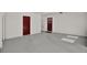 Spacious garage with gray floors and white walls and two doors, offering ample storage and functionality at 3501 63Rd N St, St Petersburg, FL 33710