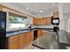 Bright kitchen featuring wood cabinets, modern appliances, and a window over the sink at 3501 63Rd N St, St Petersburg, FL 33710