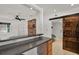 Open living room with brick fireplace, bar top, and a sliding barn door at 3501 63Rd N St, St Petersburg, FL 33710
