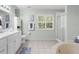 Bathroom featuring double vanity, soaking tub, shower, and tiled floors at 3668 Pond View Ln, Sarasota, FL 34235