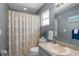 Cozy bathroom with decorative shower curtain, neutral colors, and modern sink at 3668 Pond View Ln, Sarasota, FL 34235