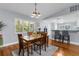 Dining area boasts a wooden table, a large window for natural light, and seamless flow to the kitchen at 3668 Pond View Ln, Sarasota, FL 34235