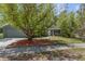 Charming single Gathering home featuring mature landscaping and a welcoming front yard and attached garage at 3668 Pond View Ln, Sarasota, FL 34235