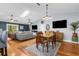 Bright open-plan living and dining area with hardwood floors and comfortable seating at 3668 Pond View Ln, Sarasota, FL 34235