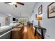 A well-lit open concept living room with hardwood floors flowing to the dining area and kitchen at 3668 Pond View Ln, Sarasota, FL 34235
