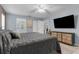 Spacious bedroom featuring natural light, a ceiling fan, and a TV on the wall at 3668 Pond View Ln, Sarasota, FL 34235