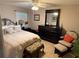 Cozy bedroom with a comfortable bed, dark wood furniture, and natural lighting from the window at 37401 Teaberry Loop, Zephyrhills, FL 33542
