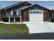 Charming single-story home with brick accents, a well-maintained lawn, and a two-car garage at 37401 Teaberry Loop, Zephyrhills, FL 33542