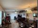 Open-concept living and dining area featuring tile floors, neutral walls, and a large window at 37401 Teaberry Loop, Zephyrhills, FL 33542