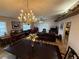 Spacious living room and dining area features tiled floors, chandelier, and ample room for entertaining at 37401 Teaberry Loop, Zephyrhills, FL 33542