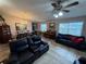 Spacious living room and dining area features tiled floors, ceiling fan, and abundant natural light at 37401 Teaberry Loop, Zephyrhills, FL 33542