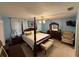 Comfortable main bedroom featuring a four-poster bed, ceiling fan, and en-suite bathroom at 37401 Teaberry Loop, Zephyrhills, FL 33542