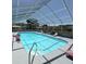 Sparkling in-ground screened pool and sun loungers, perfect for relaxation and entertainment at 37401 Teaberry Loop, Zephyrhills, FL 33542
