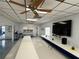 Bright, large recreation room with tables, ceiling fans and a flat-screen TV at 37401 Teaberry Loop, Zephyrhills, FL 33542