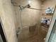 Tiled walk-in shower with grab bar and multiple shelves for storage at 37401 Teaberry Loop, Zephyrhills, FL 33542