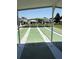View of the shuffleboard courts under a covered area with residences in the background at 37401 Teaberry Loop, Zephyrhills, FL 33542
