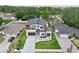 Aerial view of a contemporary home featuring a well-manicured lawn, multi-car driveway, and modern architectural design at 3817 W San Nicholas St, Tampa, FL 33629