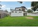 Expansive backyard of modern home with lush green grass and balcony on the second floor, creating an inviting outdoor space at 3817 W San Nicholas St, Tampa, FL 33629
