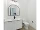 Modern half bath with a black arched mirror, sleek vanity, and elegant fixtures at 3817 W San Nicholas St, Tampa, FL 33629