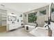 Bright bathroom with double sinks, a soaking tub, and a large window with a treeline view at 3817 W San Nicholas St, Tampa, FL 33629