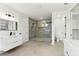 Modern bathroom with a spacious glass shower, dual vanities, and updated fixtures at 3817 W San Nicholas St, Tampa, FL 33629