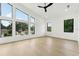 Bright bedroom with high ceilings, modern windows, ceiling fan, and light wood floors offering ample natural light at 3817 W San Nicholas St, Tampa, FL 33629