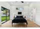 Modern bedroom with a dark color palette, and view of the backyard at 3817 W San Nicholas St, Tampa, FL 33629