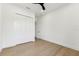 This bedroom features hardwood floors, a ceiling fan, and a spacious closet at 3817 W San Nicholas St, Tampa, FL 33629